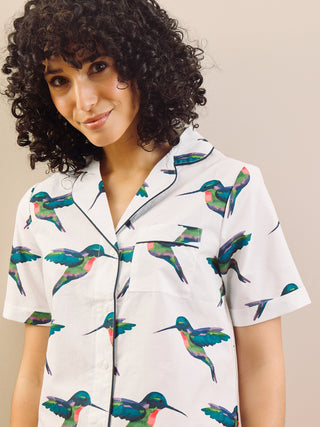 model wears a hummingbird print short pyjama set with a white base, detail