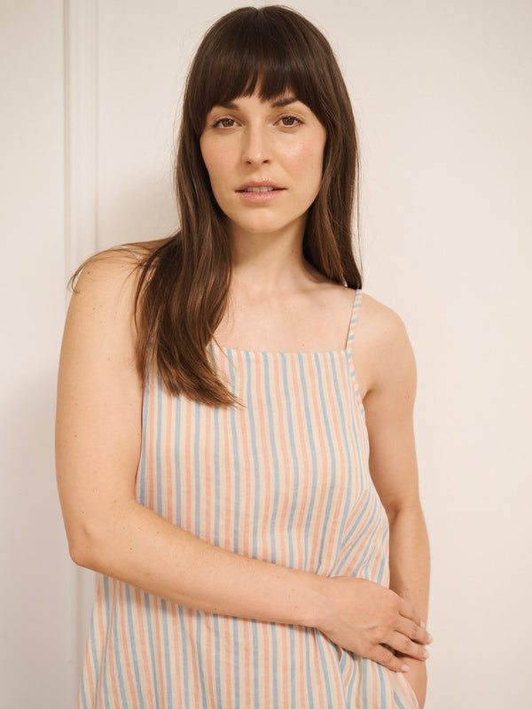 Model wearing women’s cotton gauze midi nightdress with straight neckline and slim straps, featuring baby pastel stripe print and relaxed, flowing fit.