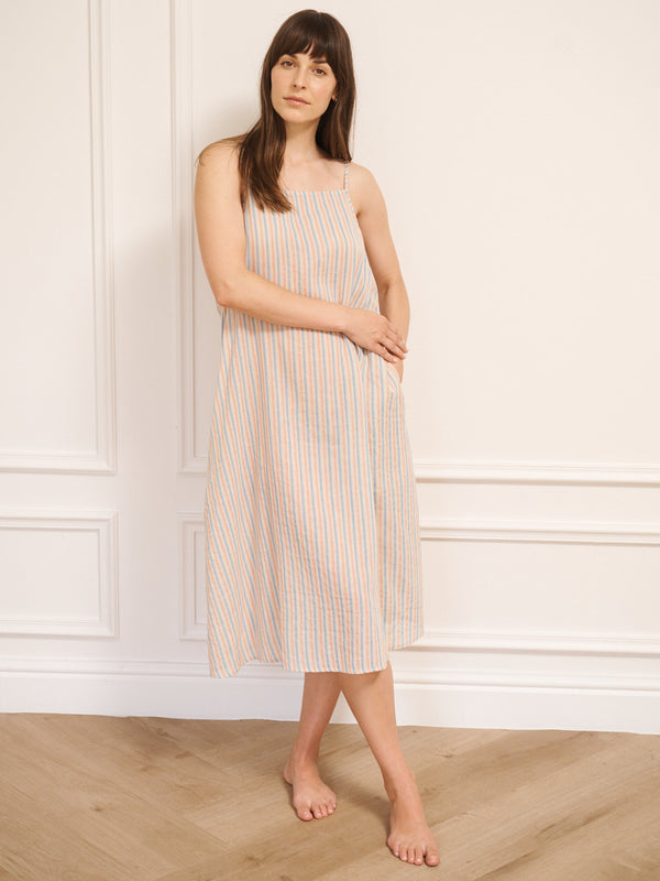Model wearing women’s cotton gauze midi nightdress with straight neckline and slim straps, featuring baby pastel stripe print and relaxed, flowing fit.