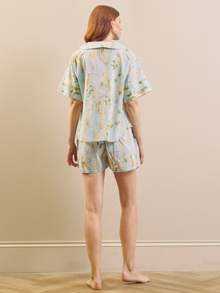 model wears a light blue and white wisteria short pyjama set. 