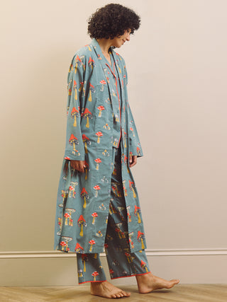 Person wearing a mushroom patterned robe and pyjama set against a plain background