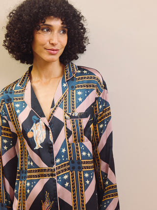 Woman wearing a patterned nightshirt with a neutral background