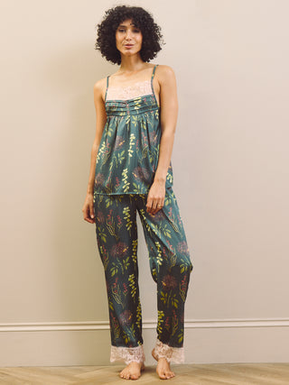 Woman wearing a floral pyjama set against a plain background