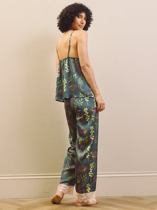Woman wearing a floral pyjama set against a plain background