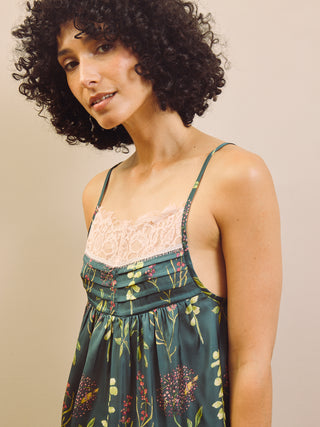 Woman wearing a floral cami night top with a beige background