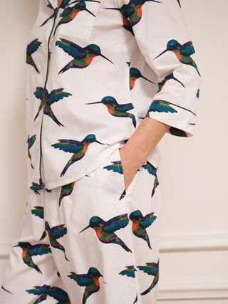 model wears humming bird print pyjamas. pocket detail.