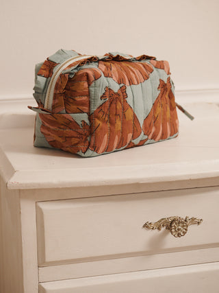 Cosmetic bag with horse pattern on a dresser