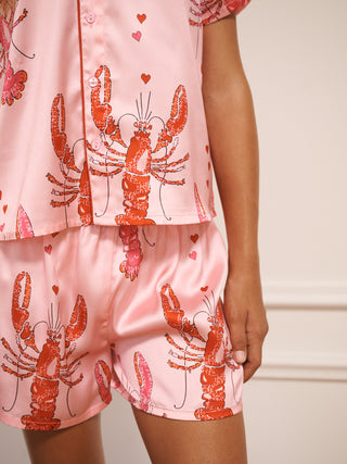 Pink short pyjama set with lobster print on a neutral background - back detail
