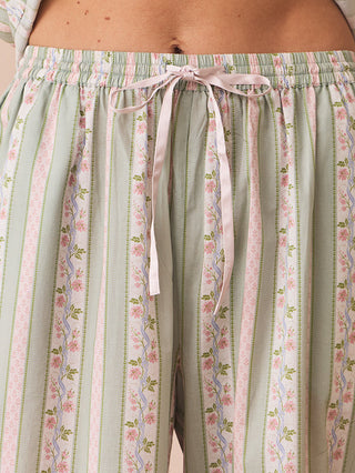 Person wearing a striped pyjama set with a neutral background
