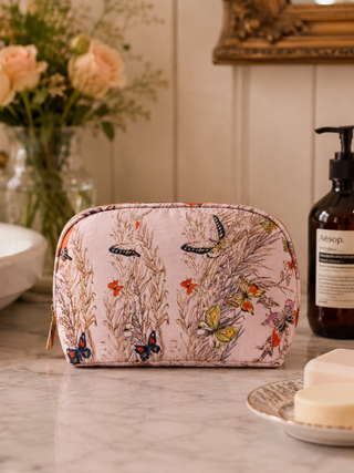 floral cosmetic bag with butterflies on a bathroom counter