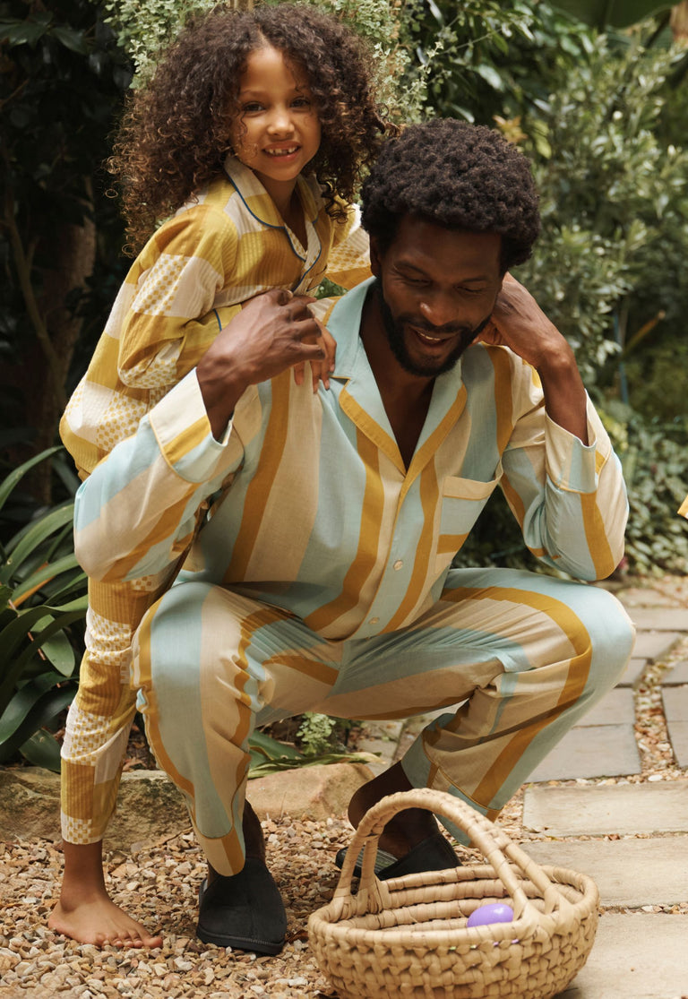 A family collecting easter eggs in their pyjamas