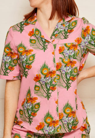 close up of mardi gras print on pink cotton