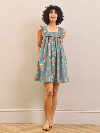 Mushroom print nightdress worn by a model against a beige wall