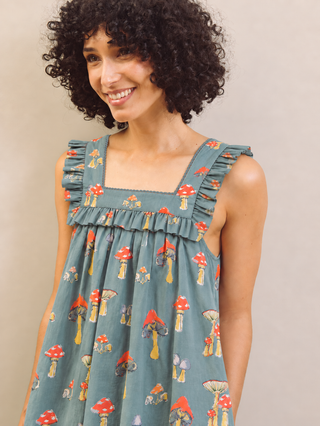 Mushroom print nightdress worn by a model against a beige wall