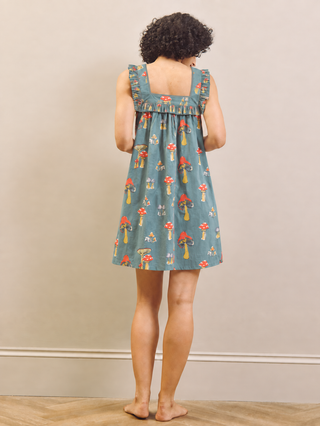 Mushroom print nightdress worn by a model against a beige wall