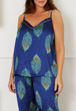 close up of peacock feather print on navy blue satin