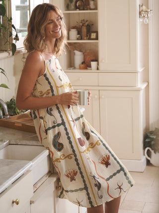 Model wears Sea Life design night dress in a kitchen