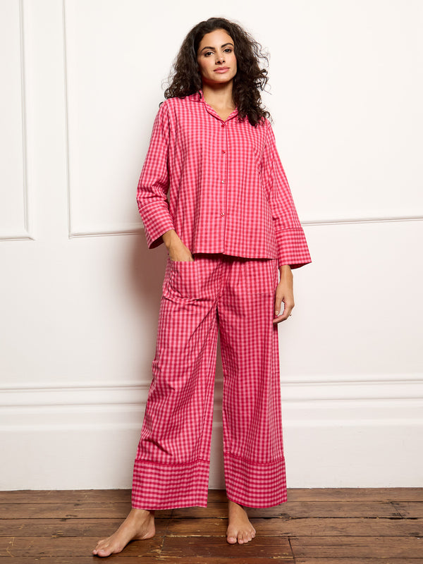 Model wears pink gingham pyjamas