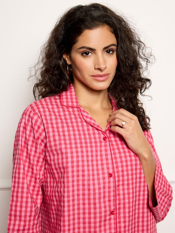 Model wears pink gingham pyjamas - focus on top
