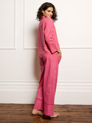 Model wears pink gingham pyjamas - focus on back