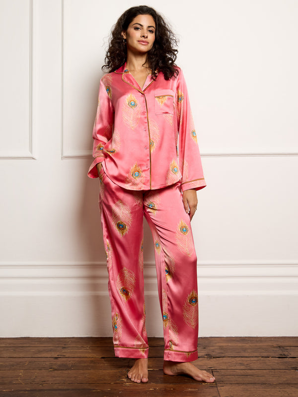 model wears pink peacock feather print satin pyjamas