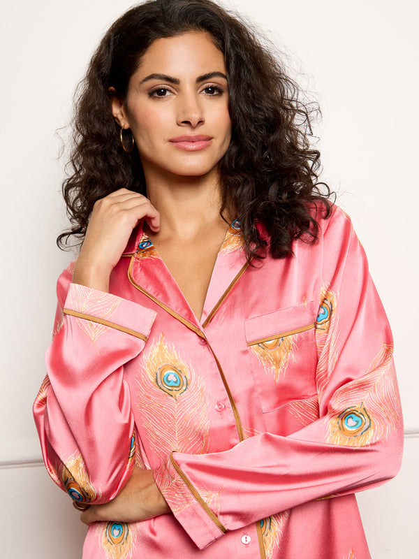 model wears pink peacock feather print satin pyjamas - focus on front