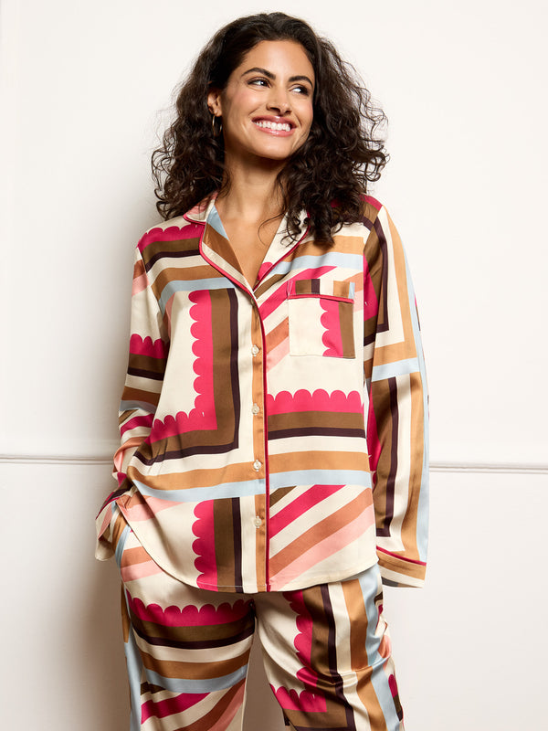 Model wears handkerchief print pyjamas in satin - focus on the shirt top