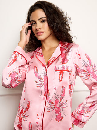 Model wears lobster print long satin pyjamas - focus on print