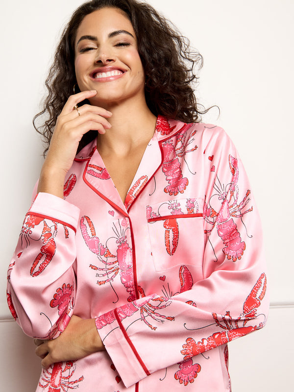 Model wears lobster print long satin pyjamas - focus on top