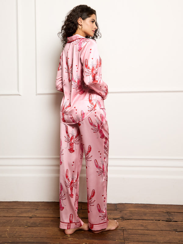 Model wears lobster print long satin pyjamas - focus on back