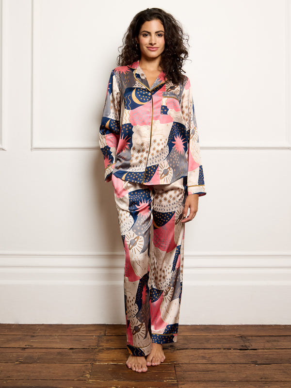 Model wears recycle satin pyjamas with moon and star print