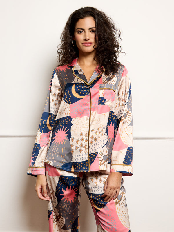 Model wears recycle satin pyjamas with moon and star print