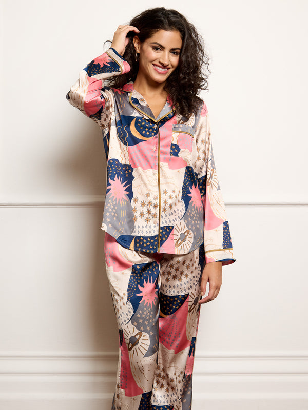 Model wears recycle satin pyjamas with moon and star print