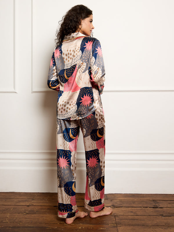 Model wears recycle satin pyjamas with moon and star print - back shot