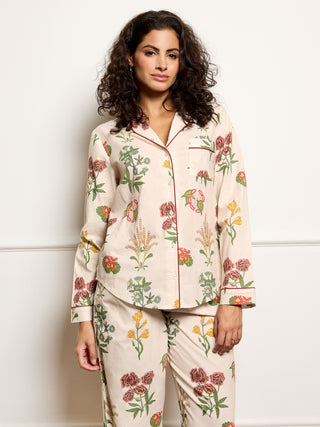 Woman wearing a floral pyjama set against a white background
