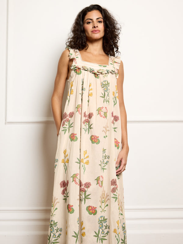 Woman wearing a floral dress against a white background