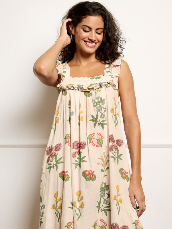 Woman wearing a floral night dress against a white background