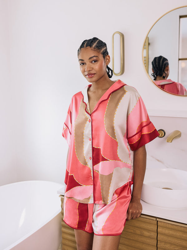  woman wearing pink oversize satin pyjama short set