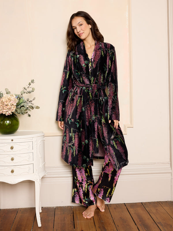 woman wearing black velvet robe with purple wisteria print