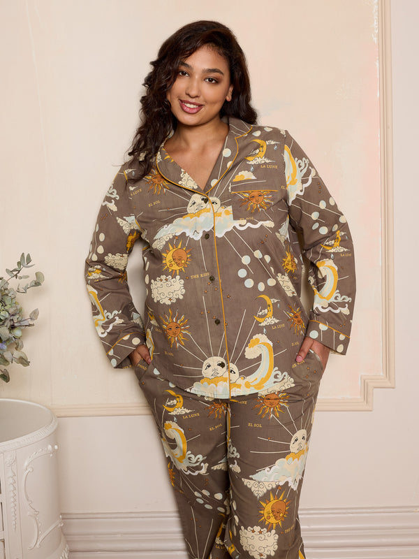 Woman wearing a grey celestial pyjama set in a bedroom