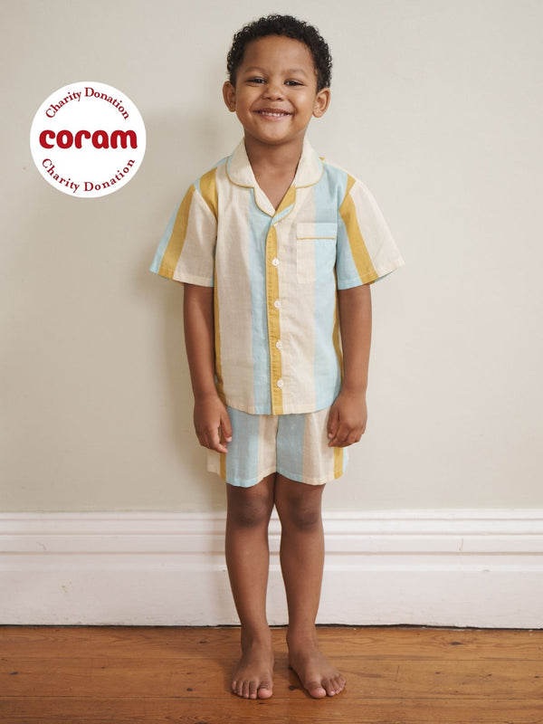 Child models wears striped pyjama set with short sleeves. 