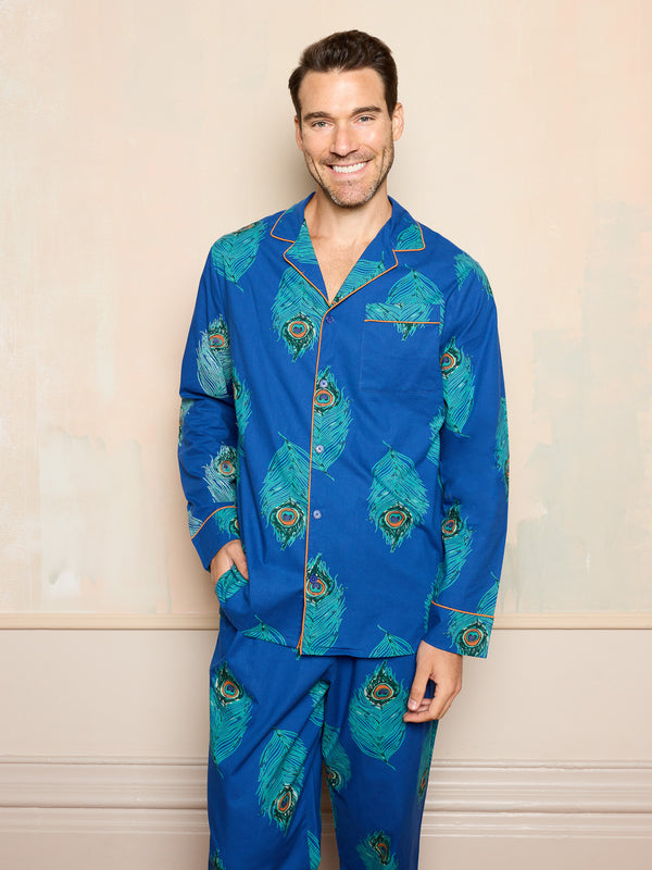 man wearing blue cotton pyjamas with peacock feather pattern with his hand in the trouser pocket