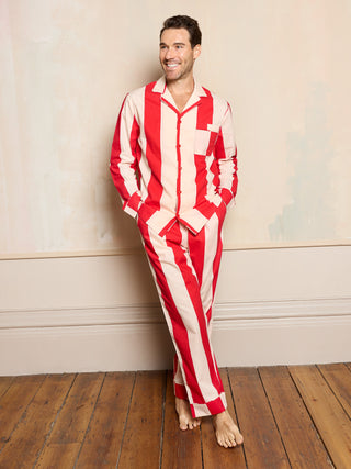 man wearing red stripe cotton pyjamas with his hands in the trouser pockets
