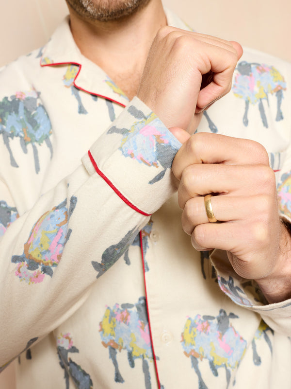 Man wearing a brushed cotton pyjama set with sheep pattern showing the softness of the fabric