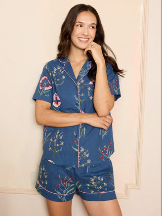 Woman wearing a blue floral cotton pyjama set with shorts