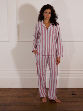 Models wears burgundy and blue stripe pyjamas