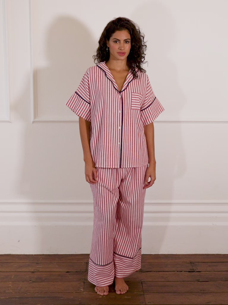 model wears candy stripe pyjamas with blue trim