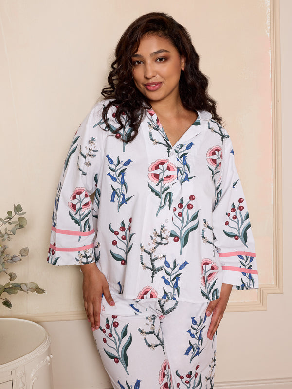 woman wearing white floral pyjama set with cropped sleeves