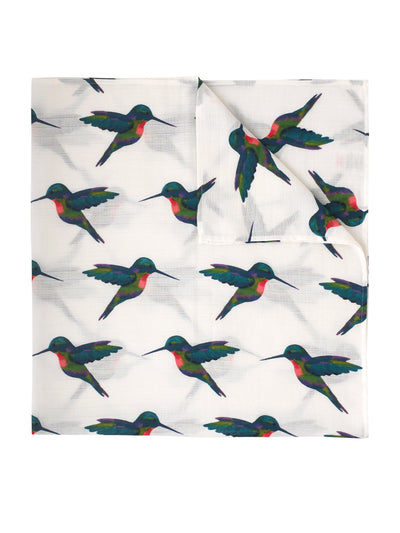 flat shot of cotton swaddle cloth, white base with hand painted multicoloured hummingbird pattern, birds in flight, in alternating directions