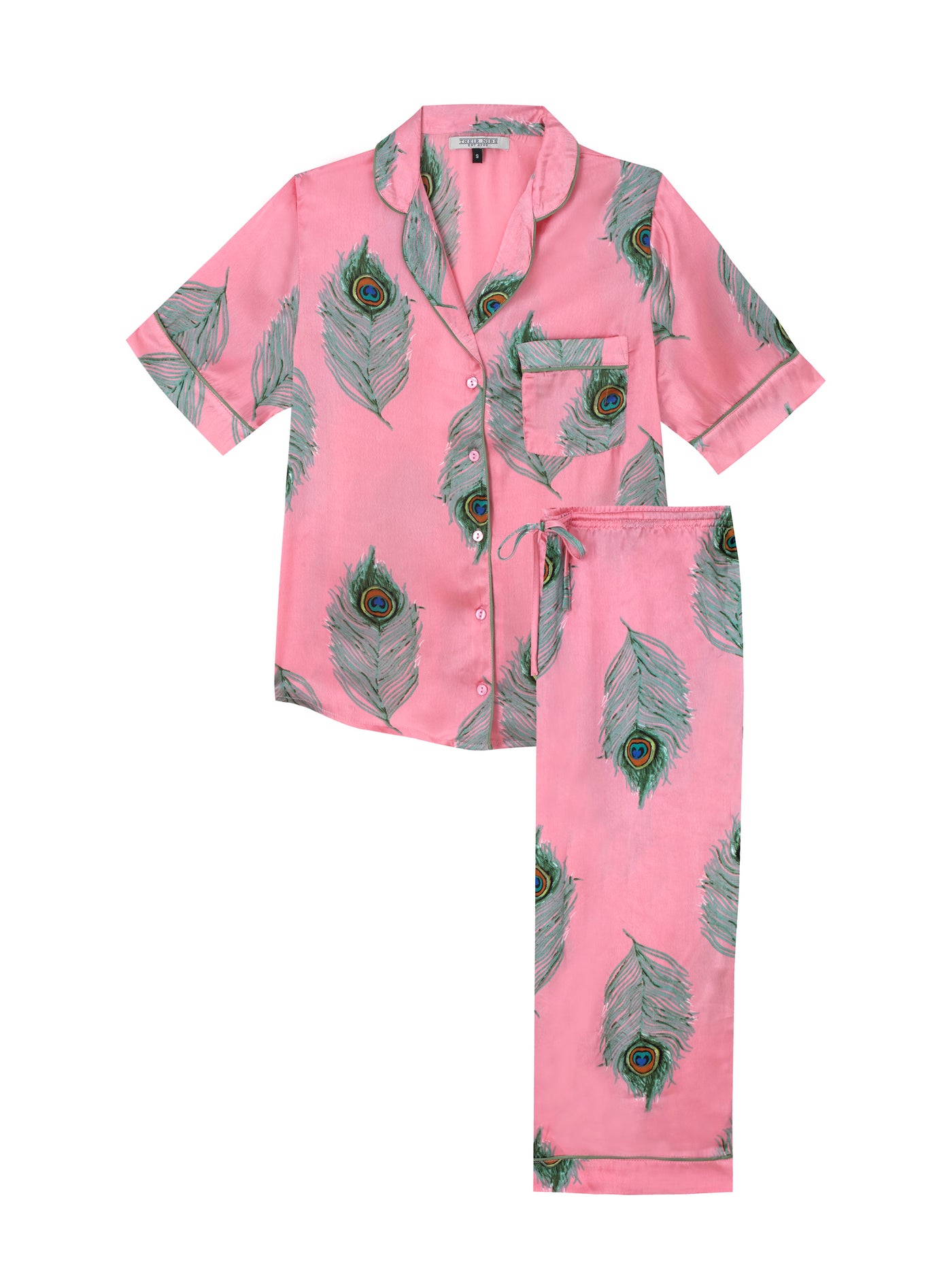 Flat shot of warm pink based ladies capri satin pyjamas, Capri length, with repeating green peacock feather pattern, green piping on cuffs and collar